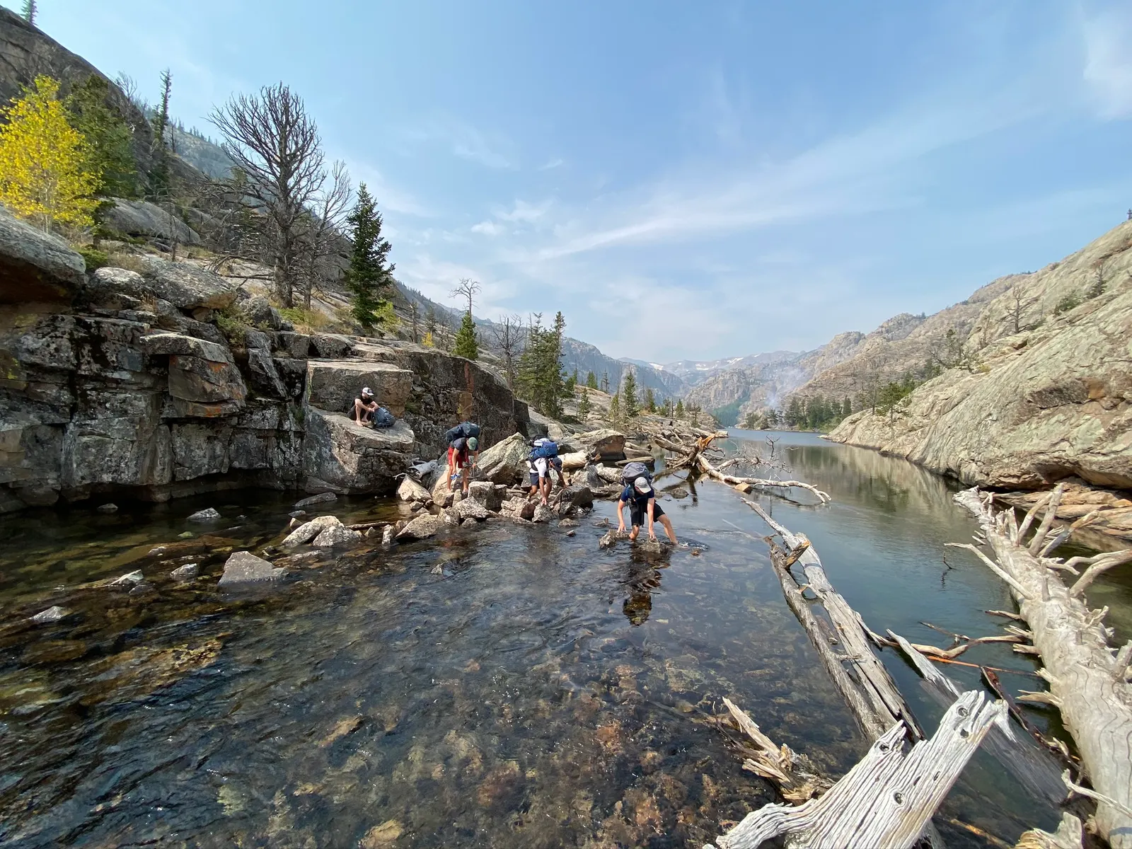 Crossing a creek below granite walls